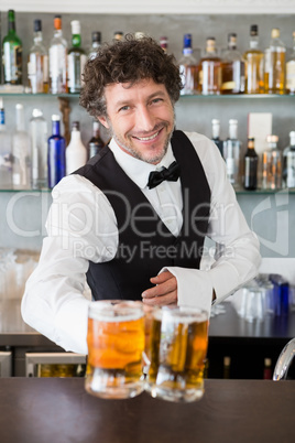 Waiter serving mug of beers Waiter serving mug of beers