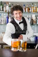 Waiter serving mug of beers
