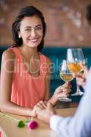 Young couple toasting wine glasses