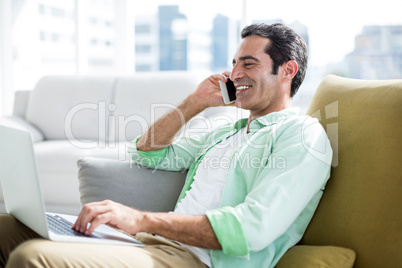 Man talking on cellphone at home