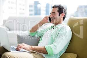 Man talking on cellphone at home