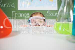 Schoolgirl doing a chemical experiment in laboratory