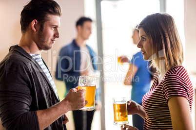 Young couple with beer mug in bar