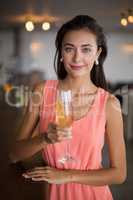 Portrait of smiling woman holding a champagne flute