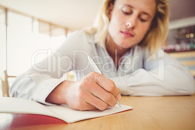 Man writing on a book