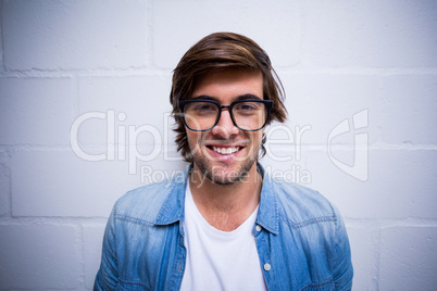 Portrait of smiling man against wall