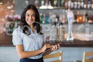 Smiling waitress holding a file
