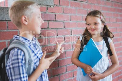 Schoolkids talking to each other in corridor