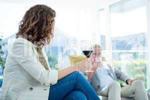 Woman by man holding wineglass
