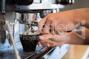 Waiter using coffee machine