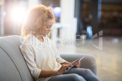 Woman using digital tablet in office