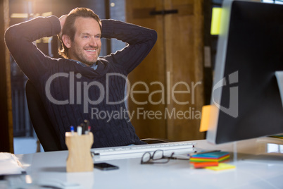 Businessman relaxing at computer desk