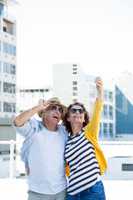 Happy couple taking selfie on walkway