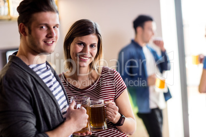 Happy young couple with beer mug