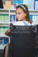 Disabled schoolgirl in library