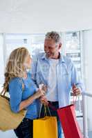 Couple holding shopping bags