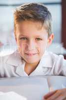 Schoolboy doing homework in classroom