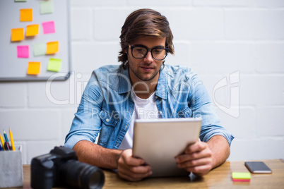 Young man using digital tablet in office