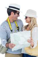 Couple looking at each other while holding map