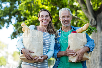 Portrait of couple holding shopping bags