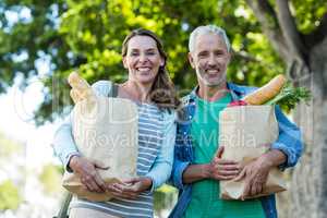 Portrait of couple holding shopping bags