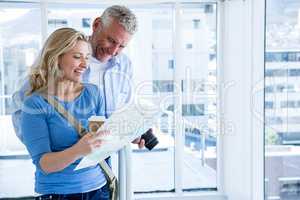 Happy mature couple reading map