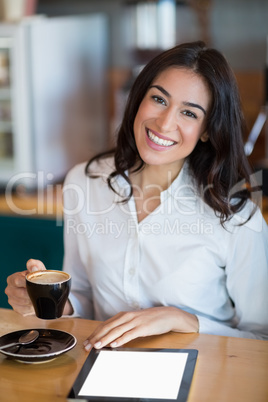 Close-up of businesswoman using digital tablet in cafÃ&#xa9