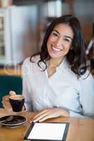 Close-up of businesswoman using digital tablet in cafÃ&#xa9