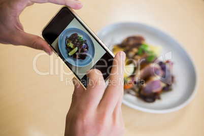 Man taking photograph of meal