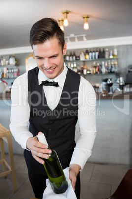 Waiter holding a bottle of wine