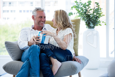 Happy mature couple with gift box