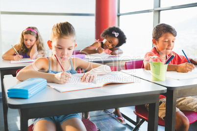 Schoolkids doing homework in classroom