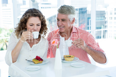 Woman with man drinking coffee at restaurant