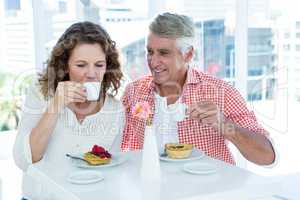 Woman with man drinking coffee at restaurant