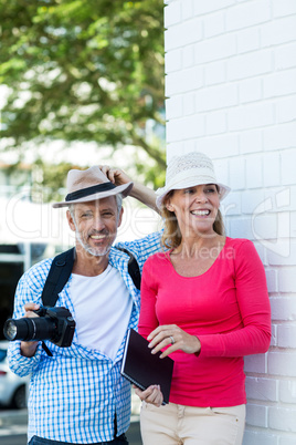 Mature couple standing by wall