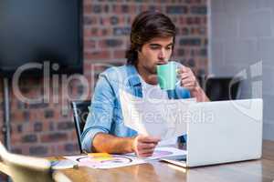 Businessman having coffee in office