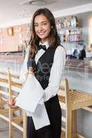 Beautiful waitress holding champagne bottle