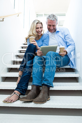 Happy couple using digital tablet