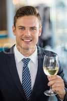 Portrait of smiling businessman holding a beer glass