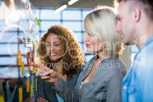 Businesswoman explaining colleagues over adhesive notes