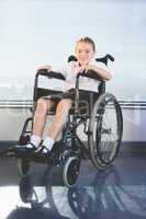 Portrait of schoolkid sitting on wheelchair
