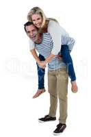 Happy man carrying woman piggyback