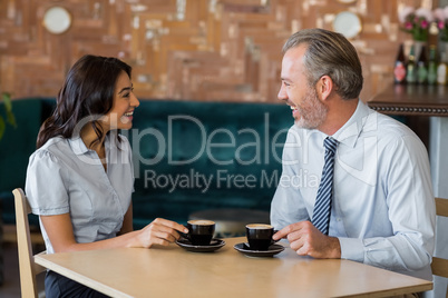 Man and woman meeting over coffee in restaurant