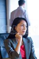 Thoughful businesswoman sitting in office