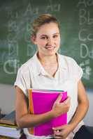 Portrait of smiling school teacher in classroom