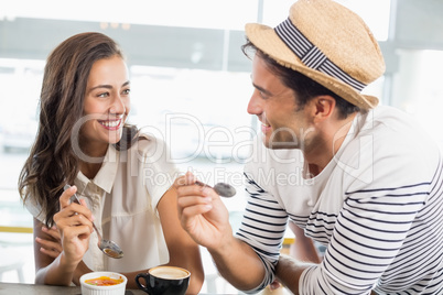 Smiling couple having dessert