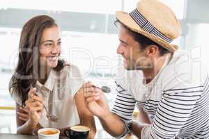 Smiling couple having dessert
