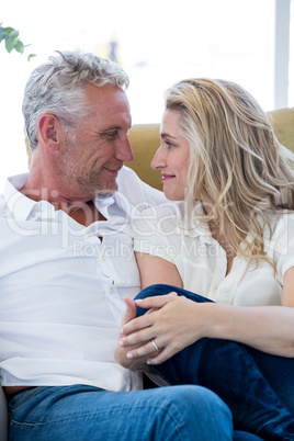 Smart mature couple sitting face to face