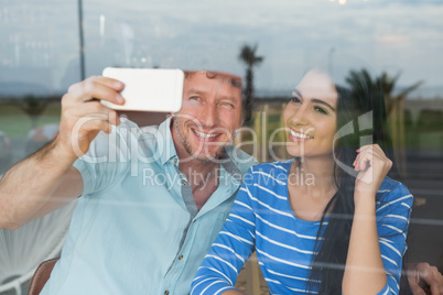 Couple taking a selfie in cafeteria