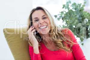 Cheerful woman talking on cellphone